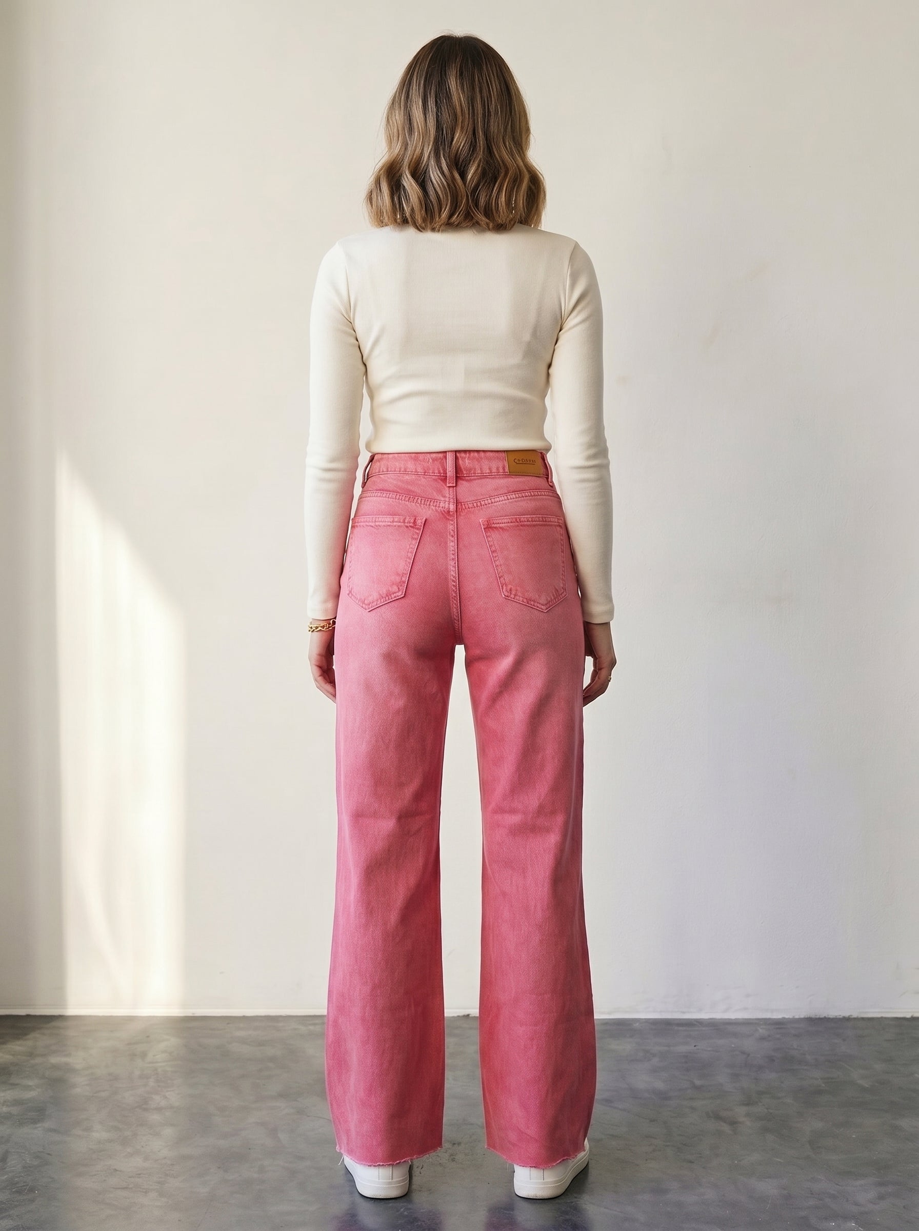 Pink high-waisted wide-leg jeans.