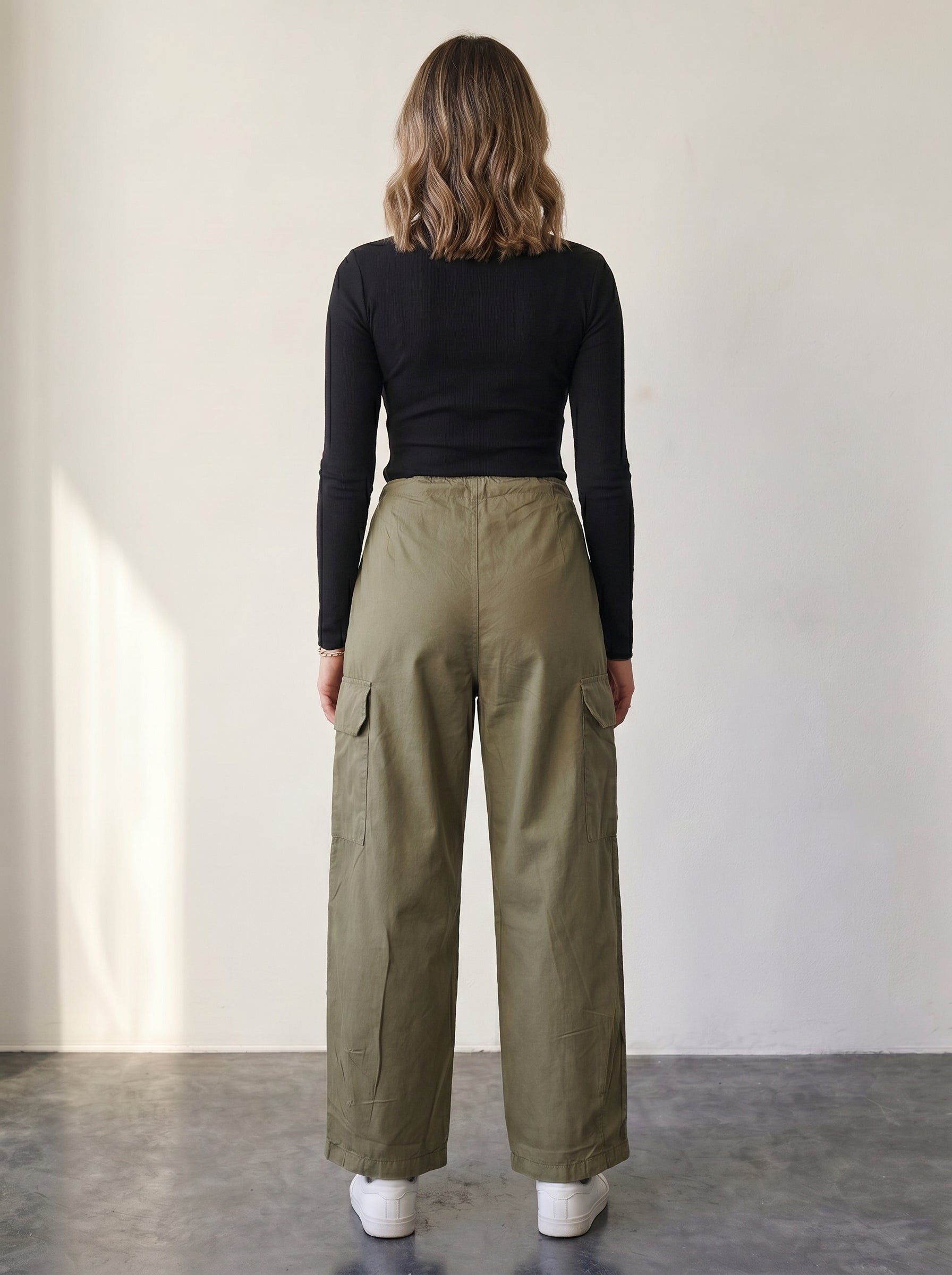 Olive high-waisted cargo pants with drawstring.