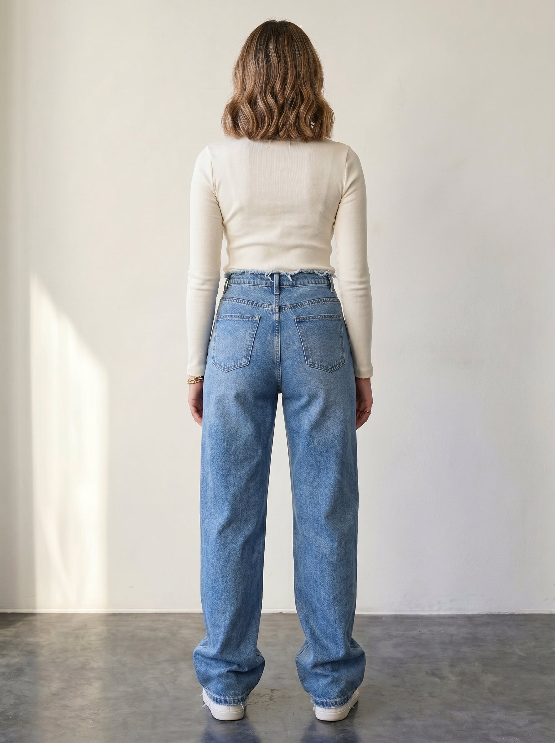 Straight-leg jeans with unfinished waist details and a high rise