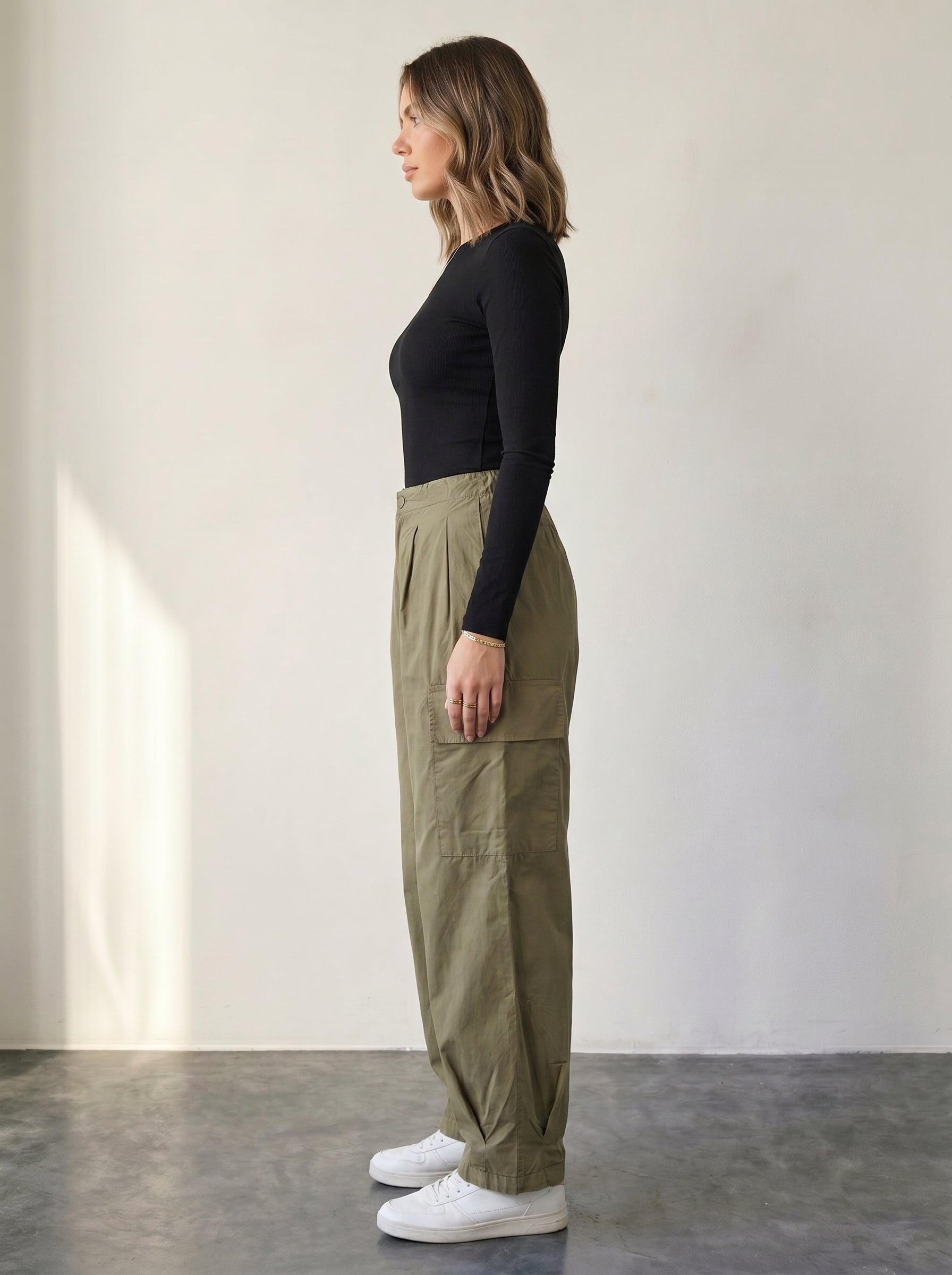 Olive high-waisted cargo pants with drawstring.