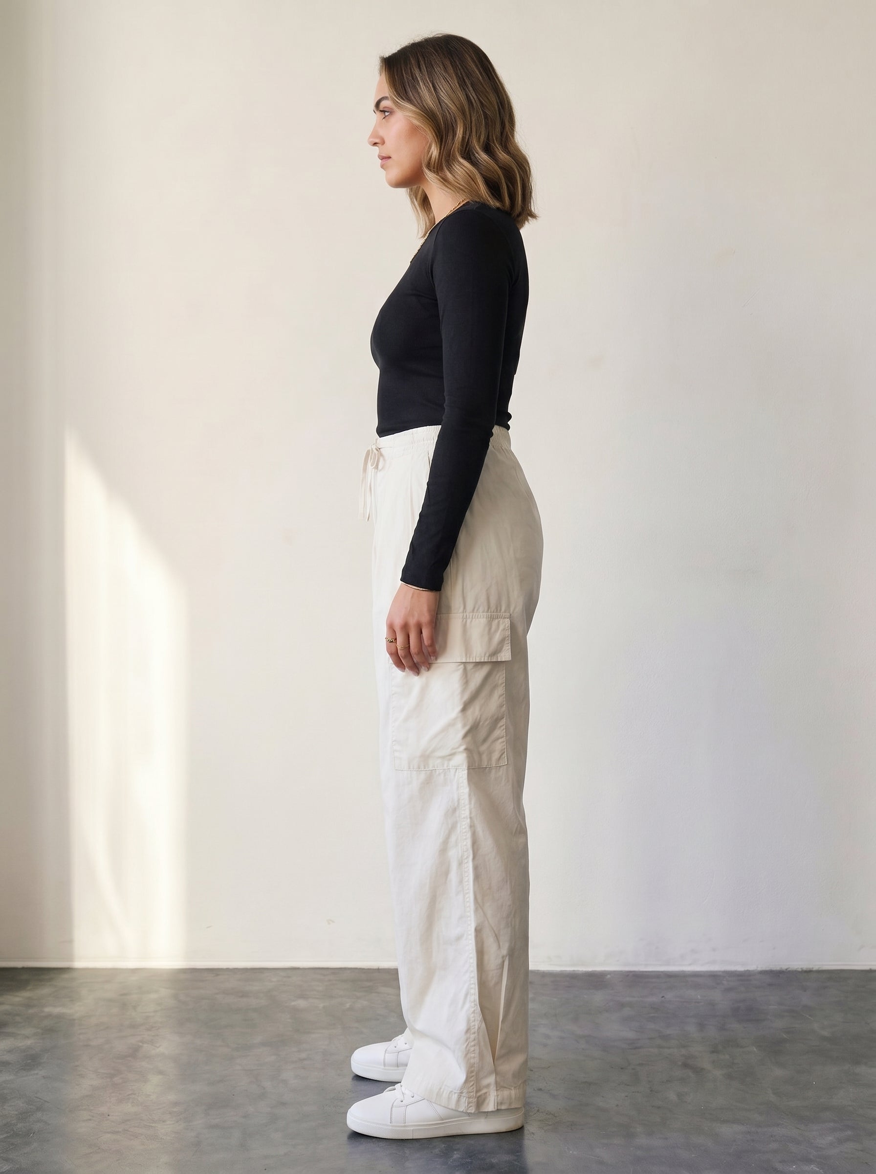 Light beige high-waisted cargo pants with a drawstring.