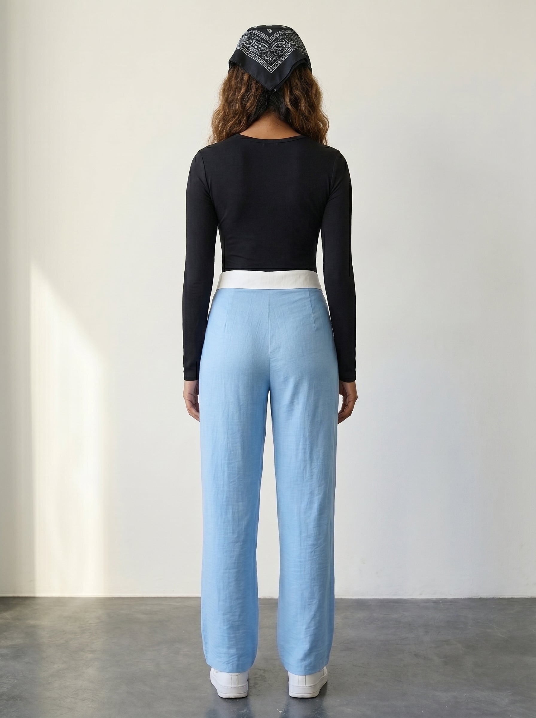 Light blue wide-leg woven trousers with a foldover collar waistband detail and a high rise
