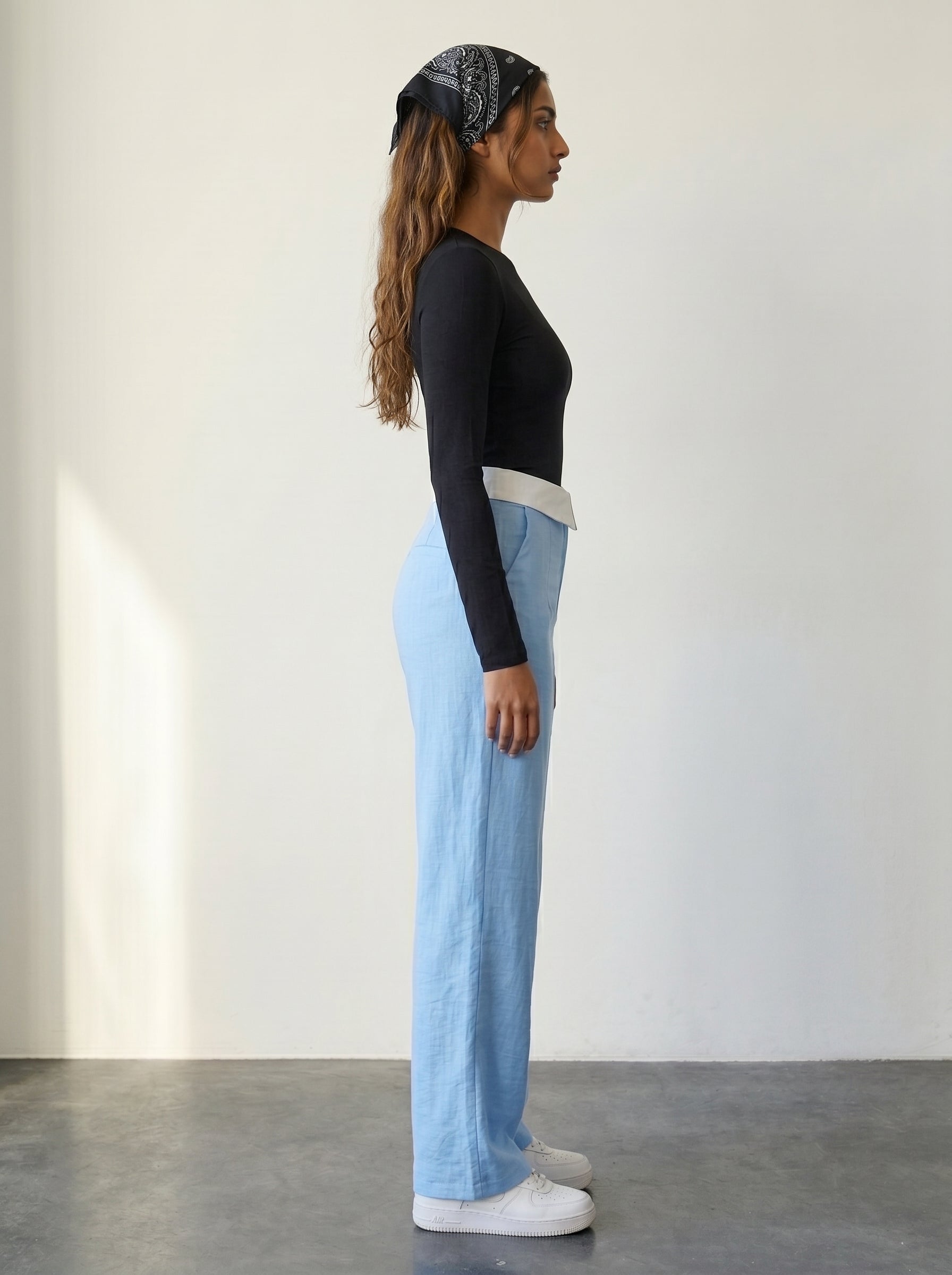 Light blue wide-leg woven trousers with a foldover collar waistband detail and a high rise