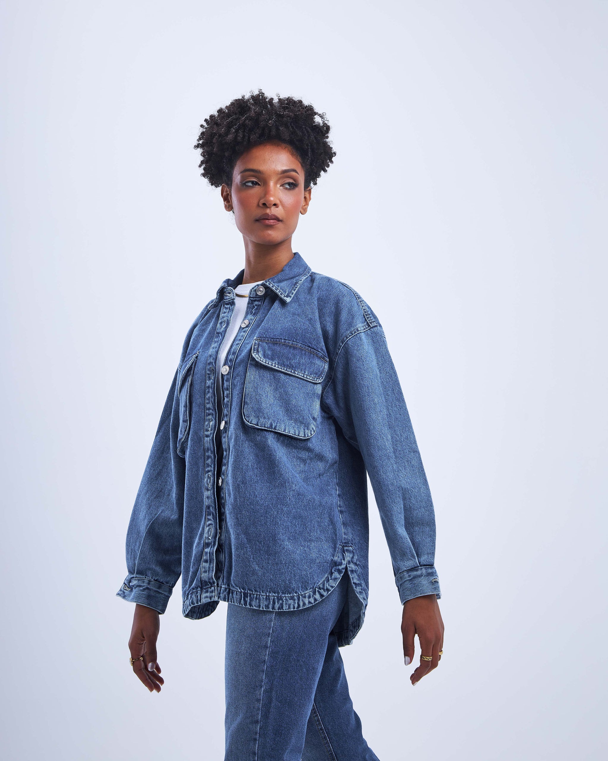 Dark blue denim jacket with front pocket details and a loose fit.