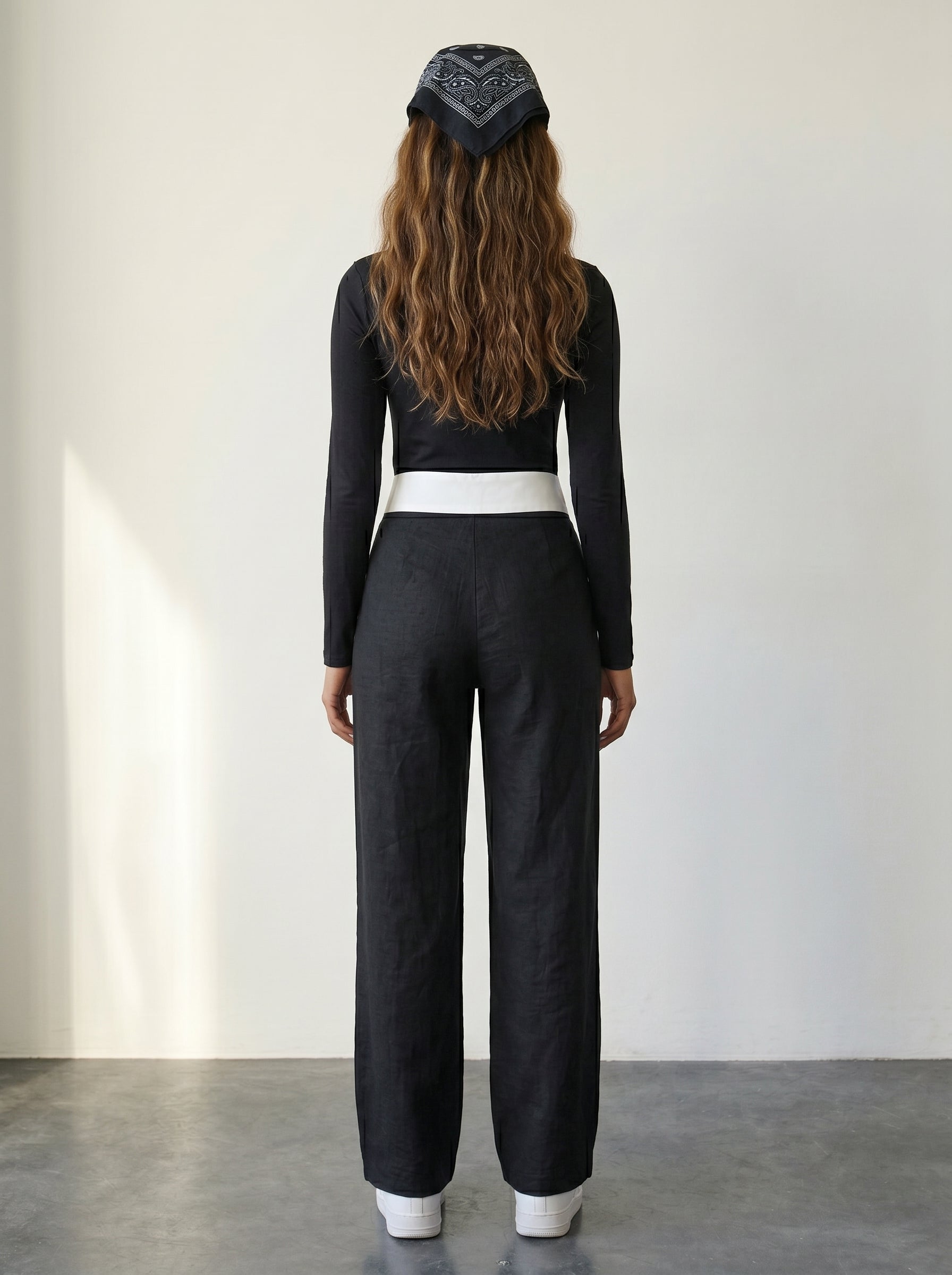 Black wide-leg woven trousers with a folded collar waist detail and a high waist