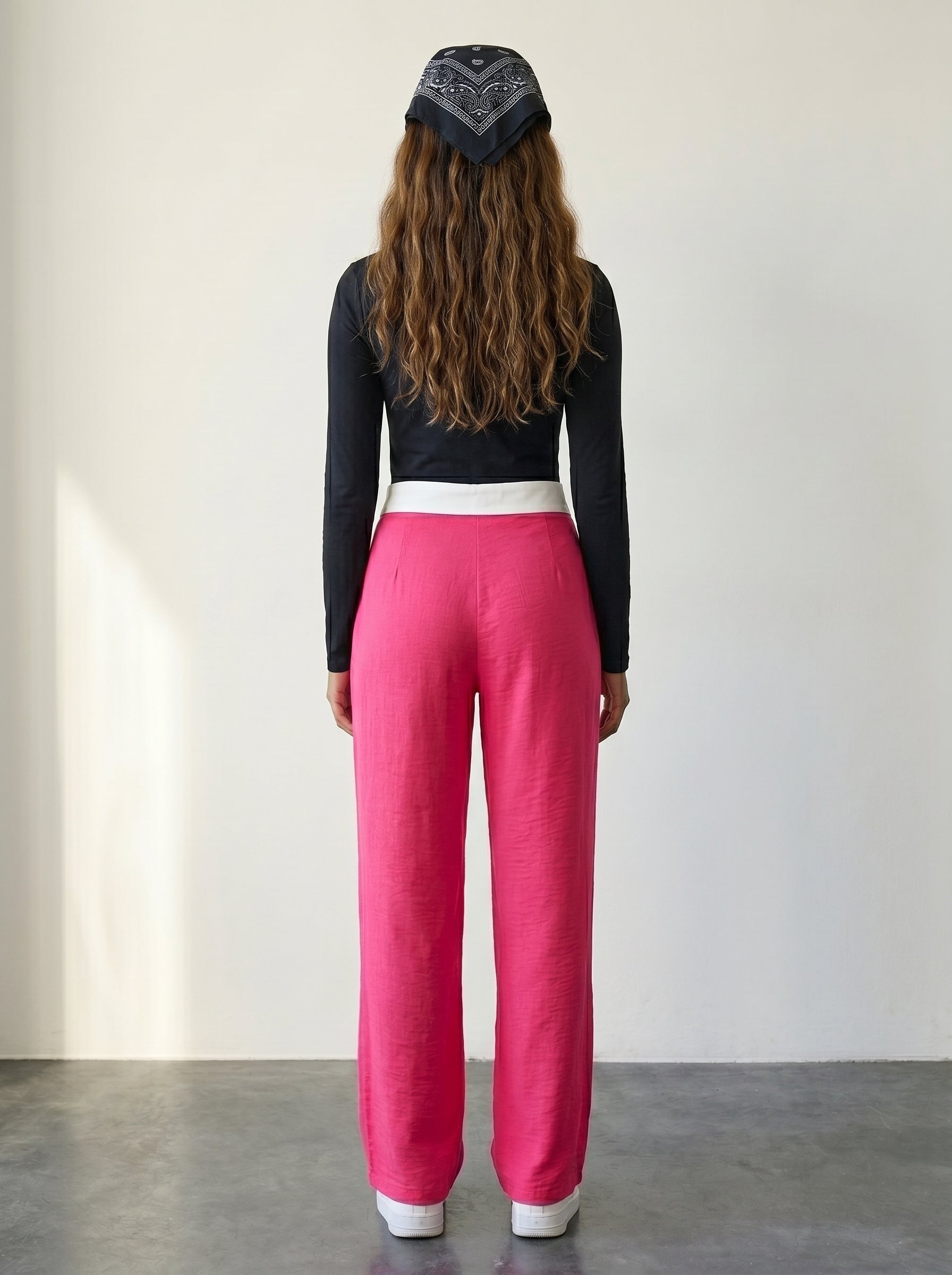 Pink knitted wide-leg pants with a fold-over waist detail and high waist